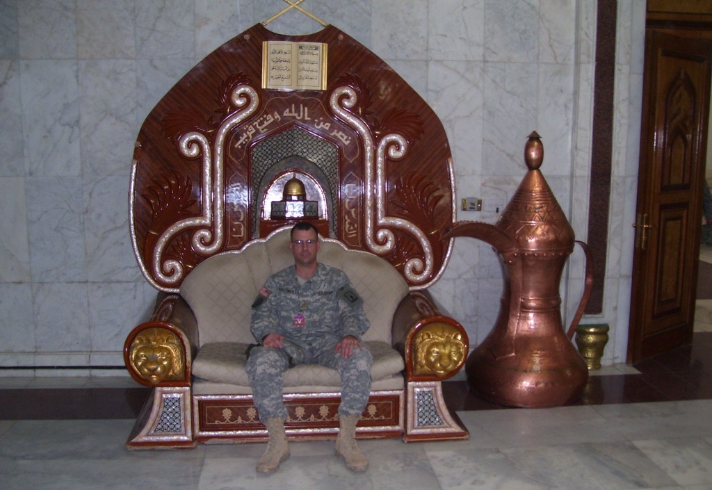 Bill Greymont sits at the Al-Faw palace in Baghdad. The chair was a gift from Yasser Arafat to Saddam Hussein in recognition of his support for the Palestinian cause.