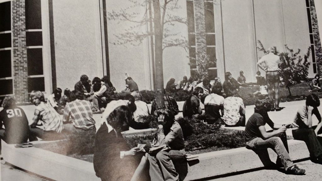 Students relax in the courtyard, as pictured in the 1975 West Bend High Schools yearbook.  It was common for students to congregate in the courtyard through the 1990s.